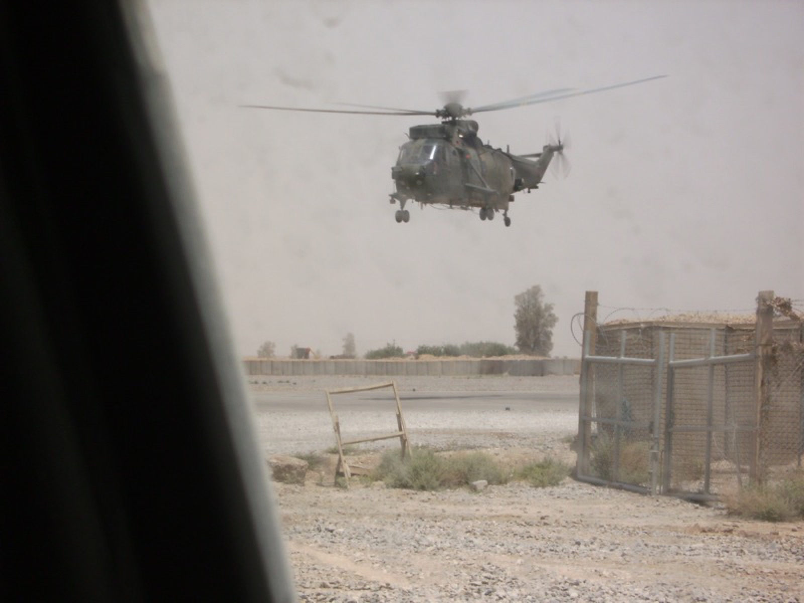 A helicopter comes in over the compound